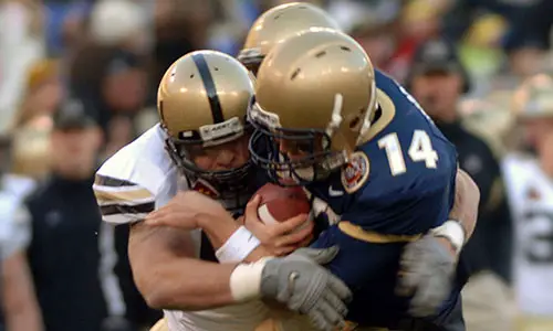 US_Navy_071201-N-6463B-543_Navy_Quarter_Back_Troy_Gross_(14)_gets_sacked_by_a_blitzing_Army_defender_at_the_108th_annual_Army_vs._Navy_football_game_at_M^T_Bank_Stadium_in_Baltimore,_MD